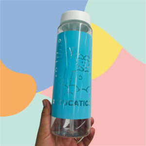 Close-up of a hand holding a blue reusable water bottle with a white cap against a pastel abstract background.